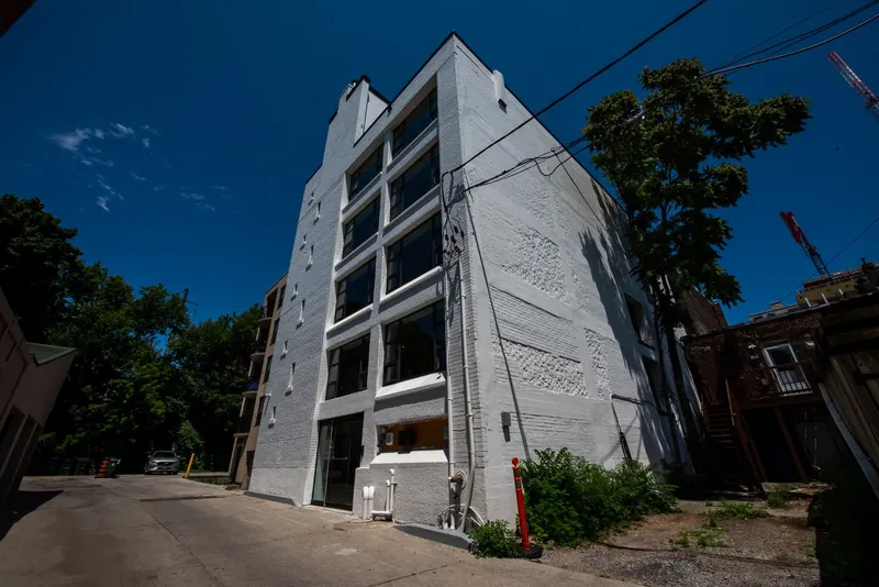 White-painted brick building after its exterior brick and repaint — 99 Crowns Lane, Toronto